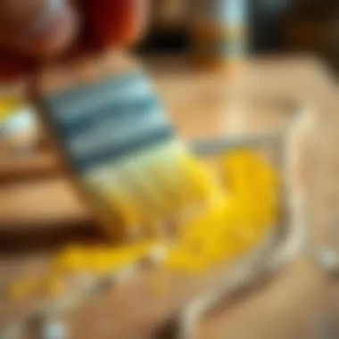 Close-up of a brush applying oil paint on wood surface