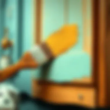 Close-up of paintbrush applying color to cabinet surface