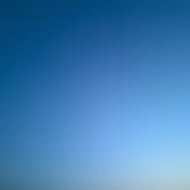 A peaceful sky at twilight showcasing a gradient of blue