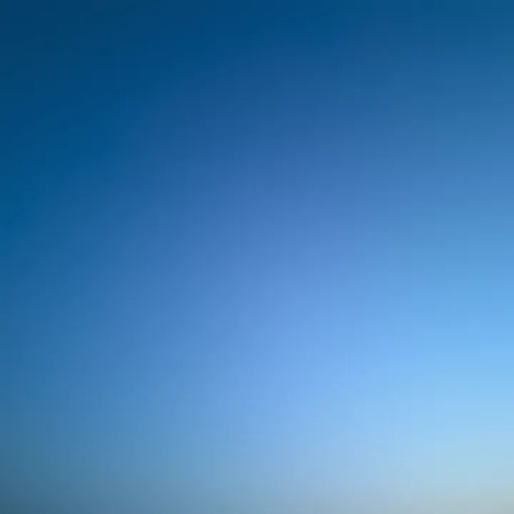 A peaceful sky at twilight showcasing a gradient of blue